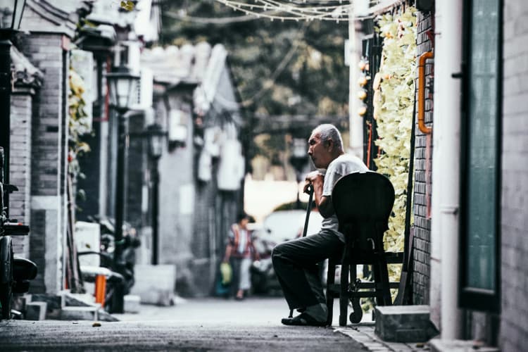 Elderly man in alleyway